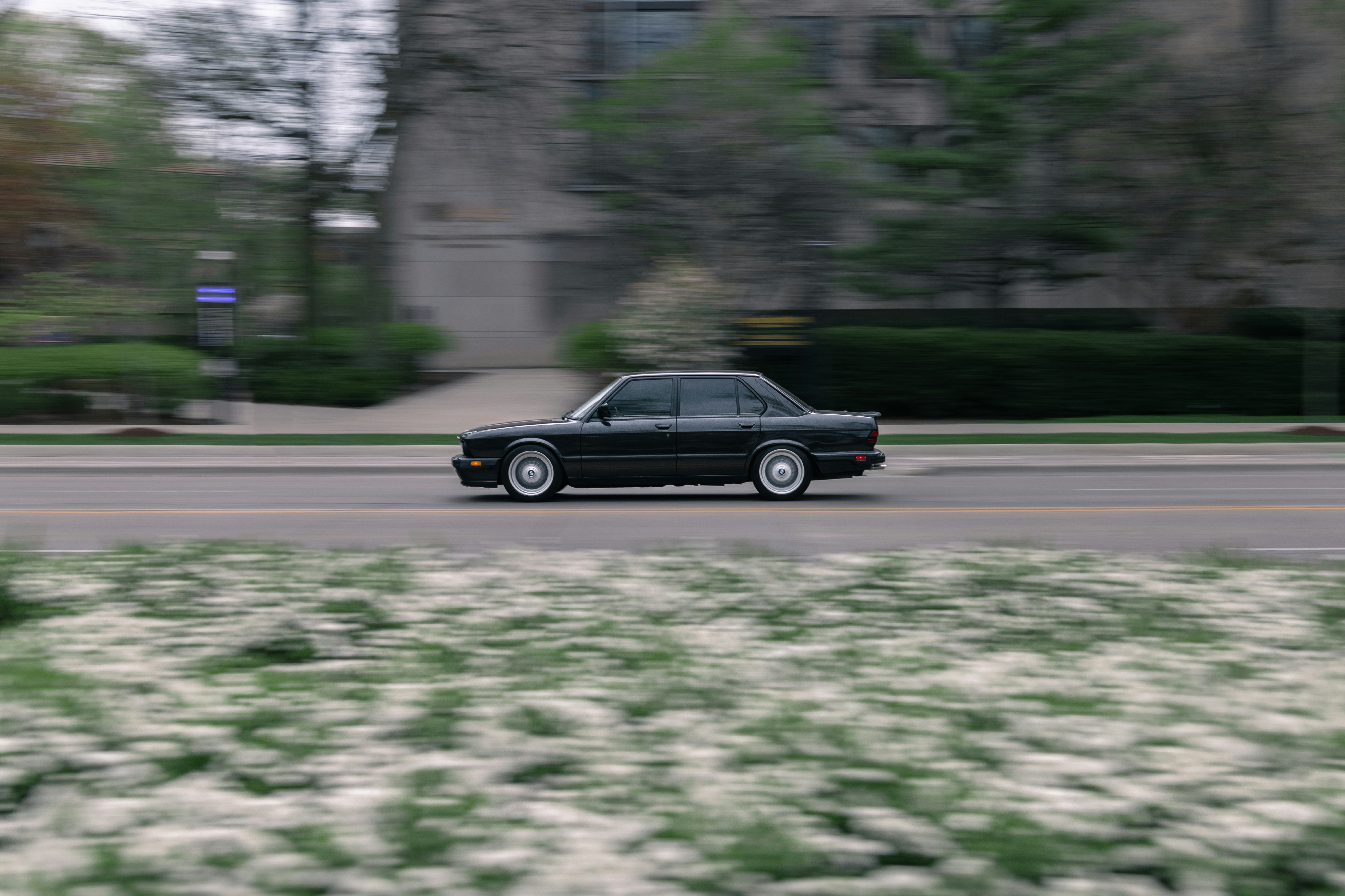 black sedan on road during daytime